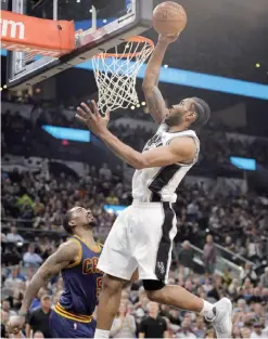  ??  ?? SAN ANTONIO: San Antonio Spurs forward Kawhi Leonard dunks during the second half of an NBA basketball game against the Cleveland Cavaliers, Monday, in San Antonio.—AP