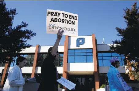  ?? Paul Chinn / The Chronicle ?? Protesters march outside a Planned Parenthood office in San Jose on Wednesday as part of the 40 Days For Life movement.