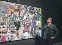 ?? ANITA SNOW/THE ASSOCIATED PRESS ?? Border artist Claudio Dicochea explains one of the paintings in his Acid Baroque exhibit Feb. 16. The exhibit will be on display at the Scottsdale Museum of Contempora­ry Art in Scottsdale, Ariz., through May 20.