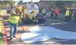  ?? CITY OF LOS ANGELES BUREAU OF STREET SERVICES ?? Street crews apply a "cool pavement" treatment on a street in Los Angeles.