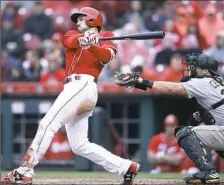  ?? Joe Robbins/Getty Images ?? Adam Duvall triples to left field to drive in a run in the fifth inning of the Reds’ win Thursday afternoon in Cincinnati.