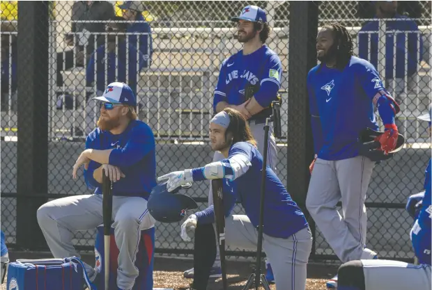  ?? FRANK GUNN / THE CANADIAN PRESS ?? Justin Turner, left, is a newcomer with the Toronto Blue Jays, who will again be led this season by Bo Bichette, centre, closer Jordan Romano, back,
and Vladimir Guerrero Jr. “The starting pitching, the bullpen, the defence, the potential lineup is insane,” Turner says.