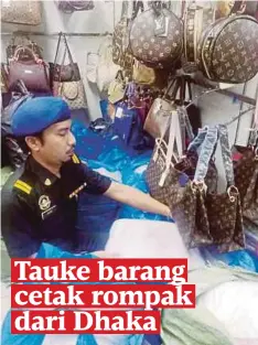  ??  ?? PEGAWAI penguat kuasa menggeleda­h barangan cetak rompak dalam operasi di Jalan Pudu dan Chow Kit.