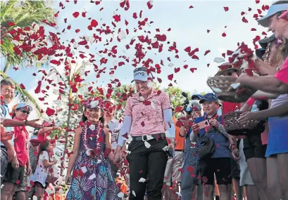  ?? JAMM AQUINO THE ASSOCIATED PRESS ?? Golf celebratio­ns are different in Hawaii, as Brooke Henderson learned for the second time at the Lotte Championsh­ip on Saturday.