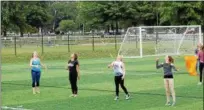  ?? KRISTI GARABRANDT — THE NEWS-HERALD ?? Mentor High School majorettes, Amanda Rose, Reilly Hoellein, April Gable, and Ari Kocab practice their routines during band practice.