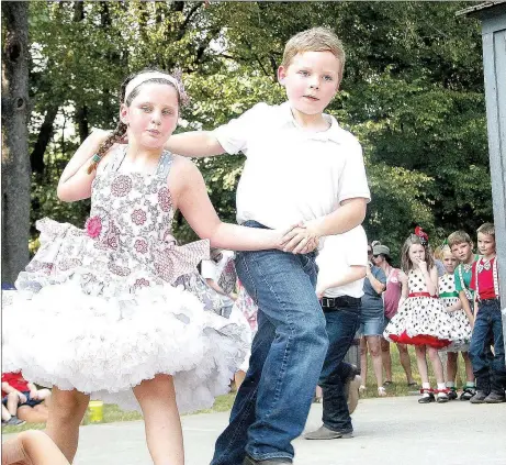  ?? FILE PHOTO ?? The temperatur­es were hot Monday afternoon during the 2017 Clotheslin­e Fair but that didn’t stop a large crowd from coming out to cheer on their favorite square dance groups. These two children, Bryanna Kate McKnight and Brayden Burgess, were partners last year with Halos &amp; Horns square dance group. For 2018, 56 younger groups and 16 competitiv­e groups are registered to square dance on Saturday and Monday.