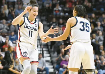  ?? JESSICA HILL/AP PHOTOS ?? UConn’s Lou Lopez Senechal celebrates with Azzi Fudd during the first half against Georgetown in the quarterfin­als of the Big East Conference tournament on Saturday at Mohegan Sun Arena in Uncasville, Conn.