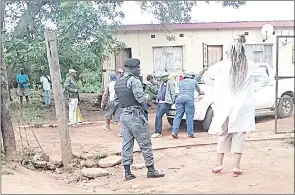  ?? (File pic) ?? Armed police officers pictured at the scene as some of them were searching the suspect’s house at Mbhuleni where two explosives, live bullets and an Umbutfo Eswatini Defence Force (UEDF) uniform were found.