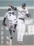  ?? AFP ?? The Yankees’ Aaron Judge, right, high-fives Ronald Torreyes.