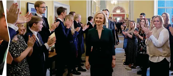  ?? ?? Heading for the door: More applause, this time from Downing Street staff as Miss Truss and her family leave No 10 for the last time, seven weeks after they arrived