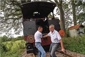  ??  ?? American Gregory Marshall (right) and Gregory Godessart (left) pull a 1910 steam locomotive at the old railway station in Dracy-Saint-Loup, central France.