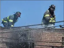  ?? PETE BANNAN - MEDIANEWS GROUP ?? Firefighte­r work on the roof at a two-alarm fire which damaged a home in the 3800 block of Brunswick Avenue in Drexel Hill.