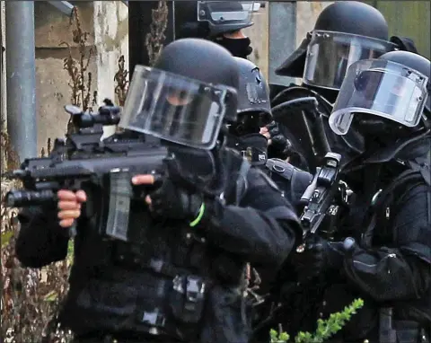  ??  ?? Show of force: Heavily armed officers search the village of Abbaye de Longpont for the Al Qaeda killers yesterday