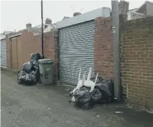  ??  ?? Rubbish piled at the rear of Courtney Smalls’ home