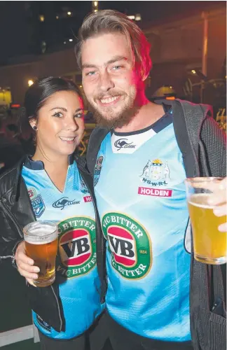  ?? Pictures: MIKE BATTERHAM ?? New South Wales fans Rebecca Davidson and James Martin celebrate their team’s victory over Queensland at the State of Origin on the Lawn event at The Star.