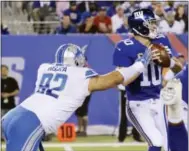  ?? BILL KOSTROUN — THE ASSOCIATED PRESS ?? Detroit’s Haloti Ngata (92) sacks Giants quarterbac­k Eli Manning (10) Monday in East Rutherford, N.J.