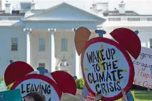  ?? Susan Walsh / Associated Press ?? Climate change protesters rally in Washington. Reduction of greenhouse gas emissions is one goal.