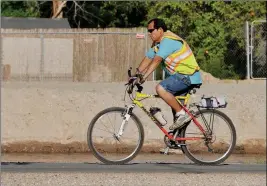  ?? Buy this photo at YumaSun.com PHOTO BY RANDY HOEFT/YUMA SUN ?? A MAN PEDALS HIS BICYCLE SOUTHBOUND along the East Main Canal bike and walking path.