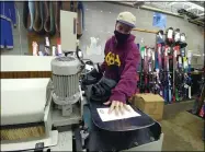  ?? ZACHARY SRNIS — THE MORNING JOURNAL ?? Jacob Hignett, ski and snowboard associate at Village Ski & Snowboard, works on a snowboard repair.