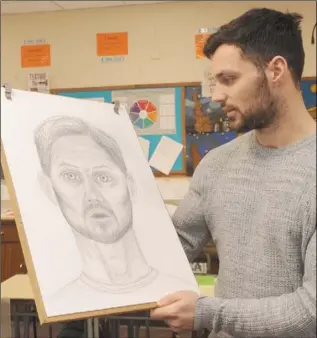  ??  ?? Patrick Hoban, Dundalk FC with a portrait created by student, Katarina Sidorova in St. Louis Secondary School.