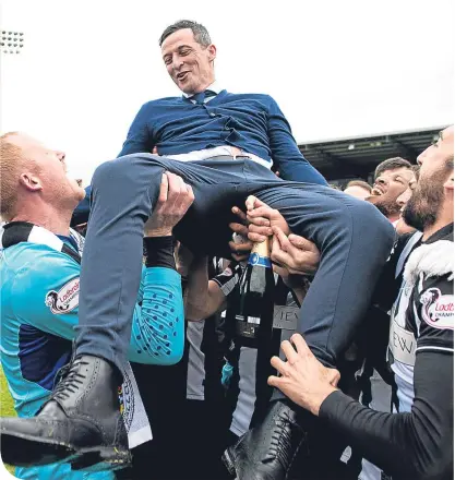  ??  ?? St Mirren manager Ross Jack is carried aloft by his players as they celebrate winning the title