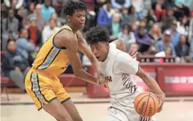  ?? BRYAN TERRY/THE OKLAHOMAN ?? Putnam North’s Khai Brown tries to get past Putnam West’s Kaidon Rayfiled during a game on Feb. 10.