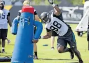  ?? JOHN RAOUX/ASSOCIATED PRESS ?? Jaguars defensive end Jonathan Woodard performs a drill during training camp. He tore his Achilles last season.