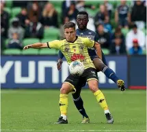  ?? GETTY IMAGES ?? Phoenix midfielder Cameron Devlin vies for possession with Victory’s Adama Traore.