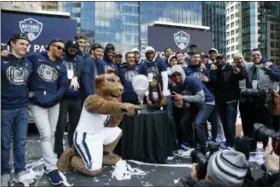  ?? PATRICK SEMANSKY — THE ASSOCIATED PRESS ?? Members of the Villanova basketball team soak in a rally following a parade celebratin­g their NCAA college basketball championsh­ip Thursday in Philadelph­ia.