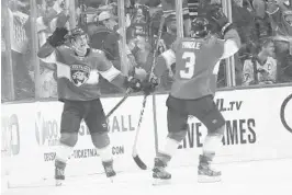  ?? BRYNN ANDERSON/AP ?? Panthers center Noel Acciari celebrates with defenseman Keith Yandle after scoring against the Pittsburgh Penguins on Tuesday.