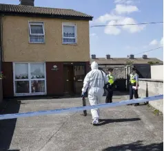  ??  ?? FOUL PLAY: Gardai at the address in Rowlagh Green, Clondalkin, where 74-year-old Tony Tims lost his life. Photo: Mark Condren