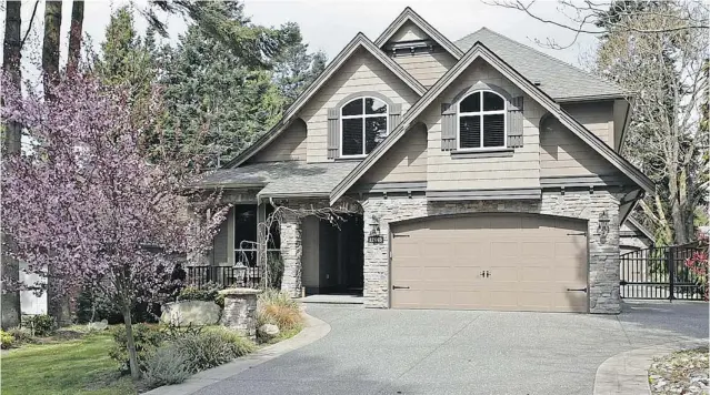  ??  ?? Custom- crafted home built in 2009 on a half- acre in the heart of Surrey’s Ocean Park showcases high ceilings, four large bedrooms on the upper floor and expansive windows that frame garden views.