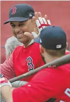  ?? STAFF FILE PHOTO BY STUART CAHILL ?? JOB WELL DONE: Alex Cora high fives J.D. Martinez before a recent game at Fenway. Cora is not taking anything for granted despite the Red Sox’ sizzling 81-34 record entering last night’s game.