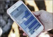  ?? BRYNN ANDERSON / ASSOCIATED PRESS ?? Alana Koer of Parkland, Fla., shows text messages she got from her son Kai during the school shooting. Kai, 17, survived.