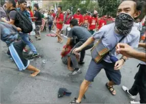  ?? BULLIT MARQUEZ — THE ASSOCIATED PRESS ?? A protester is helped by others after a Philippine National Police van rammed into protesters outside the U.S. Embassy in Manila, Philippine­s, Wednesday. A Philippine police van rammed into protesters, leaving several bloodied, as an anti-U.S. rally...