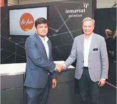  ??  ?? AirAsia X Bhd CEO Benyamin Ismail (left) with Mondale. AirAsia, through its subsidiary ROKKI Sdn Bhd, has signed a MoU with Inmarsat for its next-generation GX Aviation inflight connectivi­ty solution.