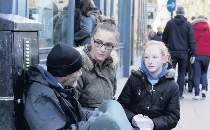  ??  ?? ■ Gemma Evans and her daughter Kristen Evans, 11, are handing out pre-paid Greggs cards to the homeless in Newcastle.