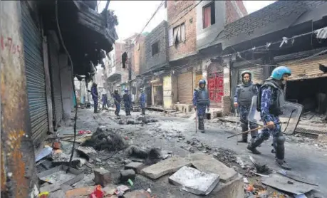  ??  ?? Anti-riot Rapid Action Force personnel patrol the violence-hit Shiv Puri area in north-east Delhi on Friday.
AMAL KS/HT PHOTO