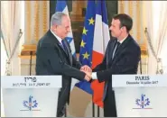  ?? STEPHANE MAHE VIA ASSOCIATED PRESS ?? Israeli Prime Minister Benjamin Netanyahu and French President Emmanuel Macron meet at the Elysee Palace in Paris on Sunday.