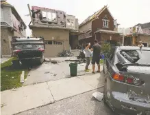  ?? JACK BOLAND / POSTMEDIA NEWS ?? An F2-Category tornado tore through south Barrie on Thursday afternoon leaving a swath of destructio­n to homes and vehicles.