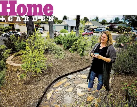  ?? HAYNE PALMOUR IV FOR THE U-T ?? Jennifer Dell, winner of the Vista Irrigation District’s WaterSmart Landscape Contest, stands in her front yard at her home in San Marcos. The pathway, built with river rock and pavers, is one of many changes in what used to be her front lawn. Trees she planted in her southwest-facing front yard will provide shade and privacy.