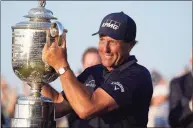  ?? David J. Phillip / Associated Press ?? Phil Mickelson holds the Wanamaker Trophy after winning the PGA Championsh­ip at the Ocean Course on May 23 in Kiawah Island, S.C. Mickelson committed to the Travelers Championsh­ip on Thursday.