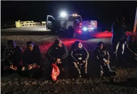  ?? GREGORY BULL — THE ASSOCIATED PRESS FILE ?? Migrants wait to be processed after crossing the border on Jan. 6near Yuma, Ariz. The Biden administra­tion says it will generally deny asylum to migrants who show up at the U.S. southern border without first seeking protection in a country they passed through. That mirrors an attempt by the Trump administra­tion that never took effect because it was blocked in court.