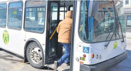  ?? DAVE STEWART/SALTWIRE NETWORK ?? A passenger climbs aboard the bus on Grafton Street in Charlottet­own on Friday. T3 Transit’s funding partners are prepared to spend up to $500,000 to purchase three pre-owned buses that will help get the fleet through the next two years until new buses can be acquired.