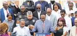  ??  ?? The Rev. Samuel Nicolas leads a prayer Monday on steps of St. Jerome’s Catholic Church in Brooklyn’s Little Haiti for victims of earthquake.