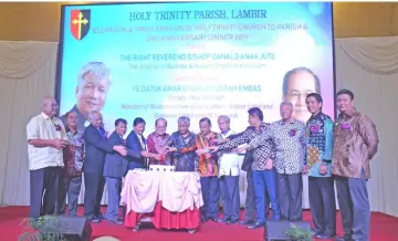  ??  ?? Uggah (sixth left) joins other distinguis­hed guests in cutting the cake to mark the second anniversar­y of Holy Trinity Parish Lambir. Also seen are Jaul (second left), Danald (seventh left), Jecksion (fourth left), Yii (left), Wilson (fifth left) and (from right) Lukanisman, Dennis, Ting and Ripin.