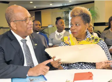  ?? IAN ALLEN/PHOTOGRAPH­ER ?? Andrew Wynter (left), CEO of the Passport, Immigratio­n and Citizenshi­p Agency, discusses the the new passport online applicatio­n portal that was launched at The Jamaica Pegasus hotel in New Kingston on Wednesday.