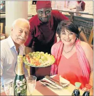  ??  ?? WHAT A TREAT! George Castis and wife, Dawn, owners of La Kouzina, at Brookes on the Bay, wait for waiter Allen Machona to serve them a scrumptiou­s offering PHOTOGRAPH: BRIAN WITBOOI