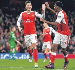  ?? Picture: Getty Images. ?? Mesut Ozil celebrates with Alex Iwobi after completing his hat-trick.