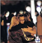  ?? [MARCIO JOSE SANCHEZ/THE ASSOCIATED PRESS] ?? Students embrace during a vigil at Central Park in the aftermath of a shooting at Saugus High School Thursday in Santa Clarita, Calif. Los Angeles County sheriff's officials say a 16-year-old student shot five classmates and then himself in a quad area of Saugus High School Thursday morning.